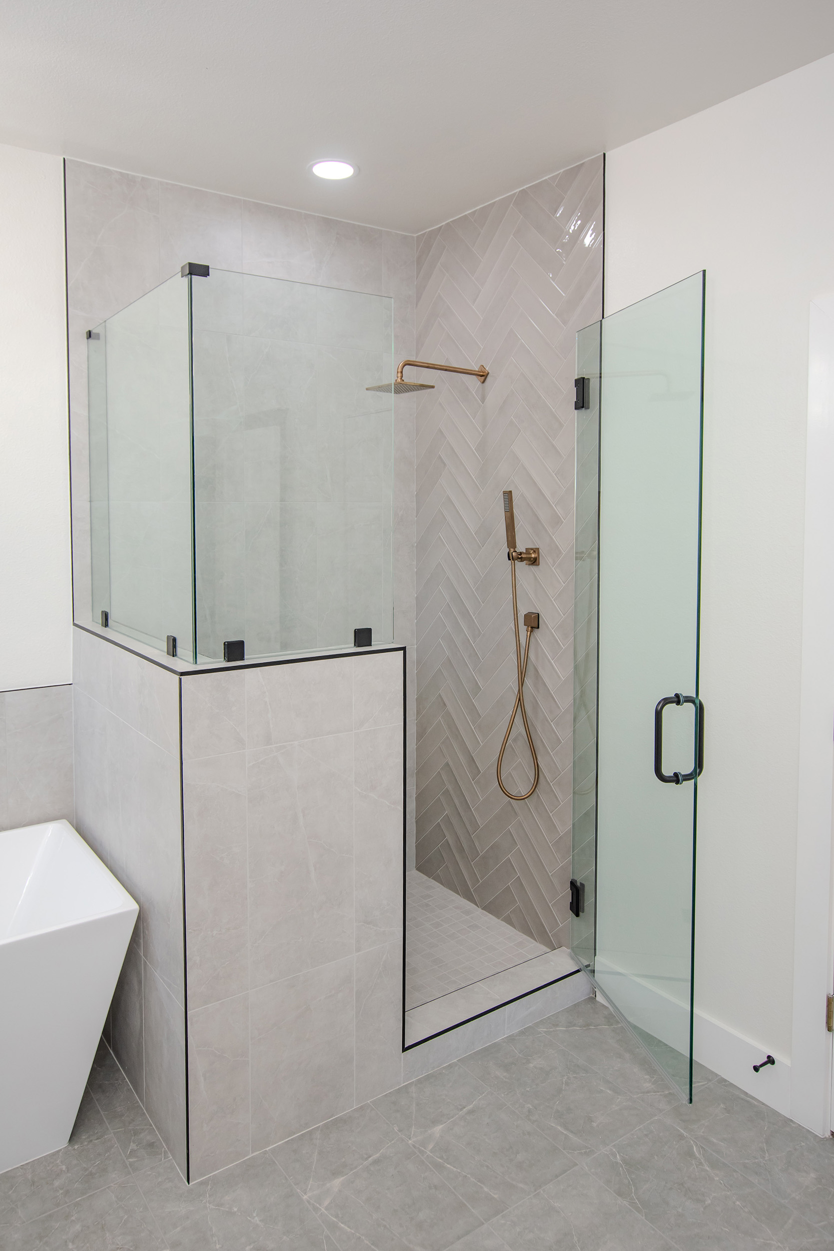 walk in shower ombre herringbone tile gold plumbing