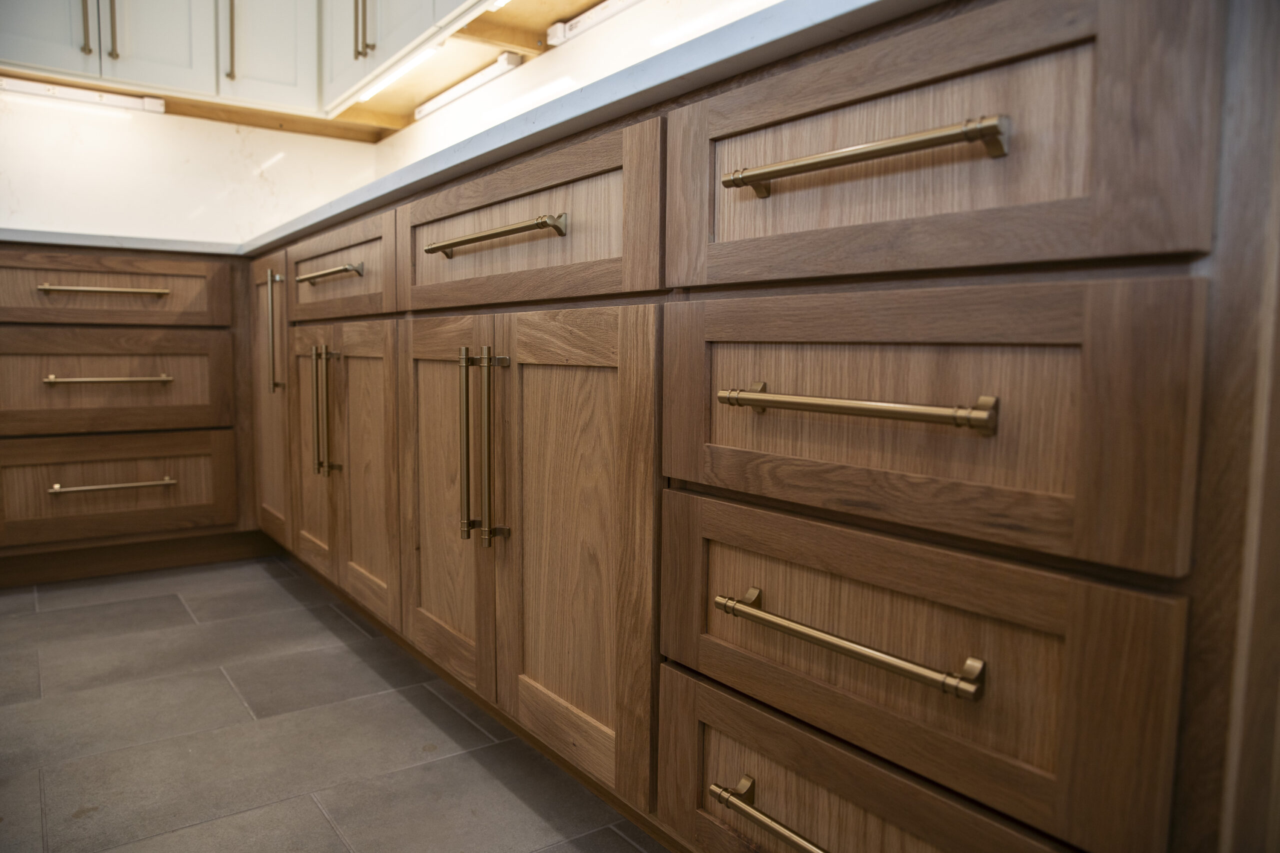 stained wood custom cabinets gold pulls