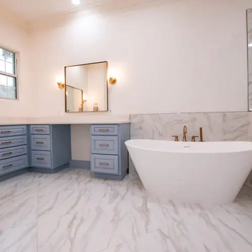 stone bathtub gold hardware bathroom remodel