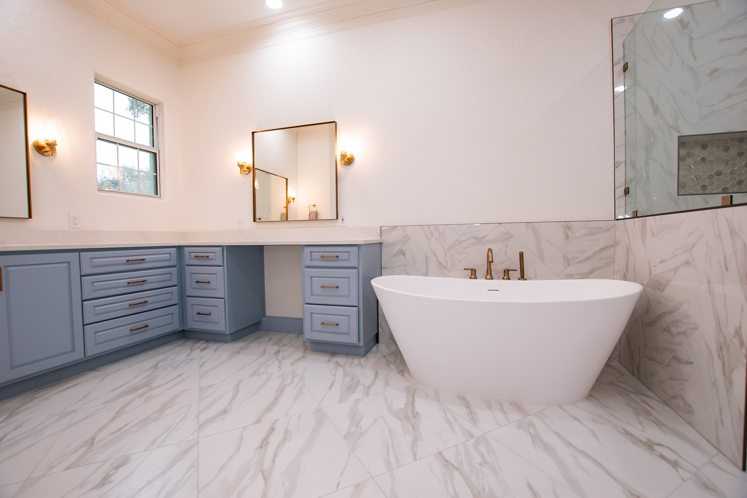 stone bathtub gold hardware bathroom remodel